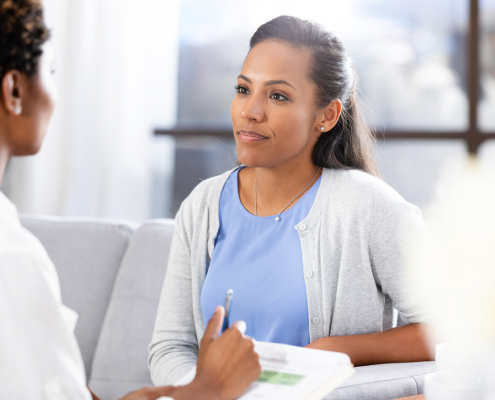 Woman talking to doctor about breast vein treatment