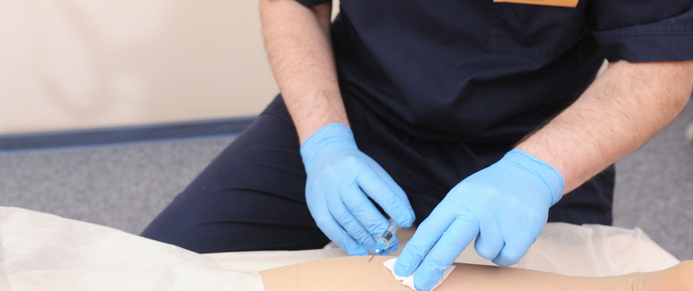 Doctor performing sclerotherapy